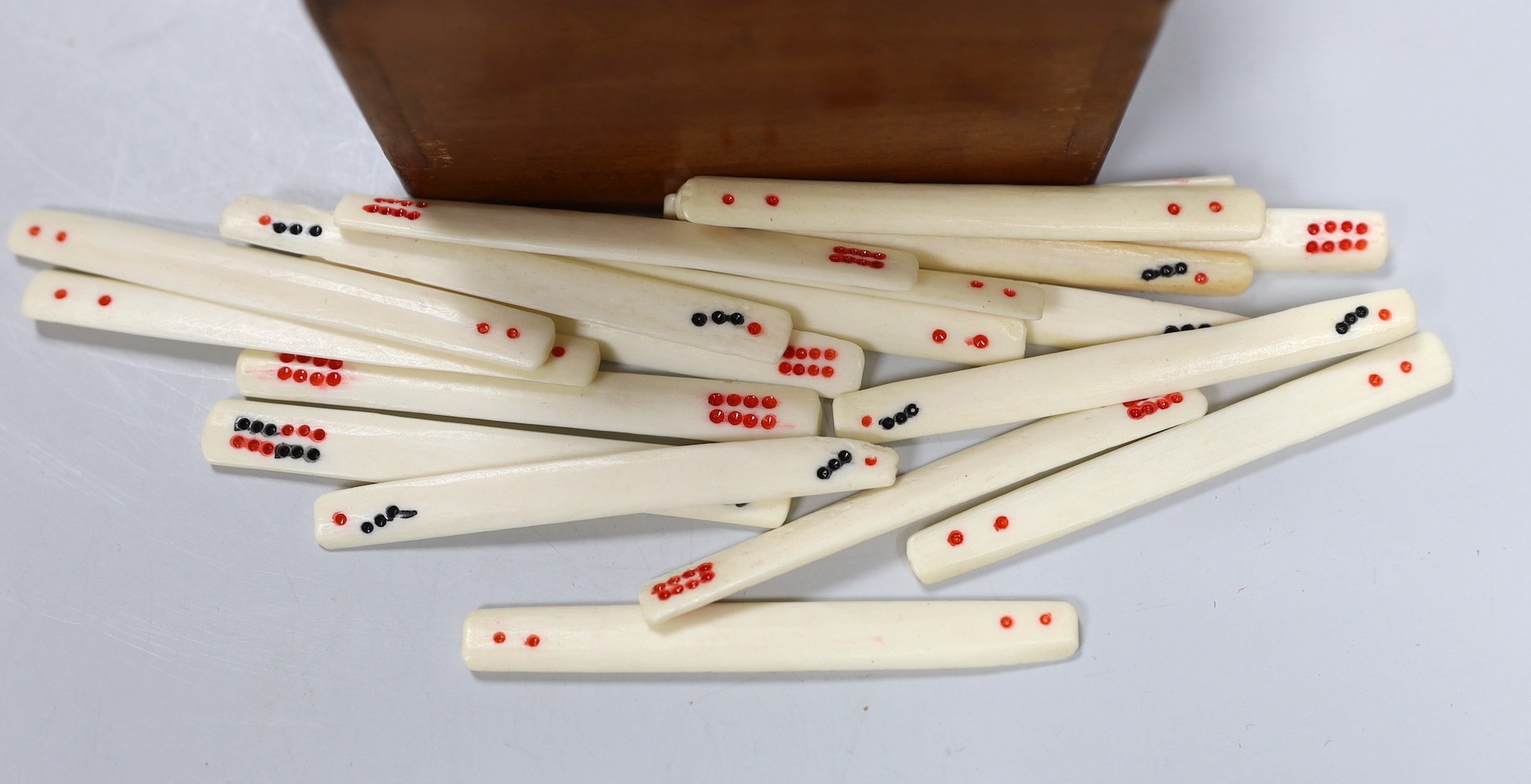 An early 20th century Chinese bone and bamboo mah jong set in two hardwood slide top boxes, largest 26.5cms wide x 5cms high